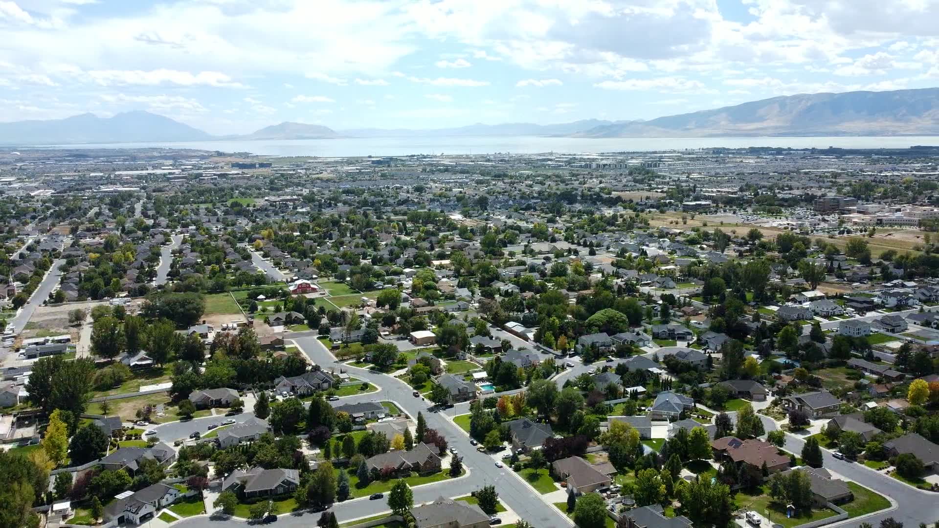 Aerial view over Utah Valley neighborhoods looking west toward Utah Lake
