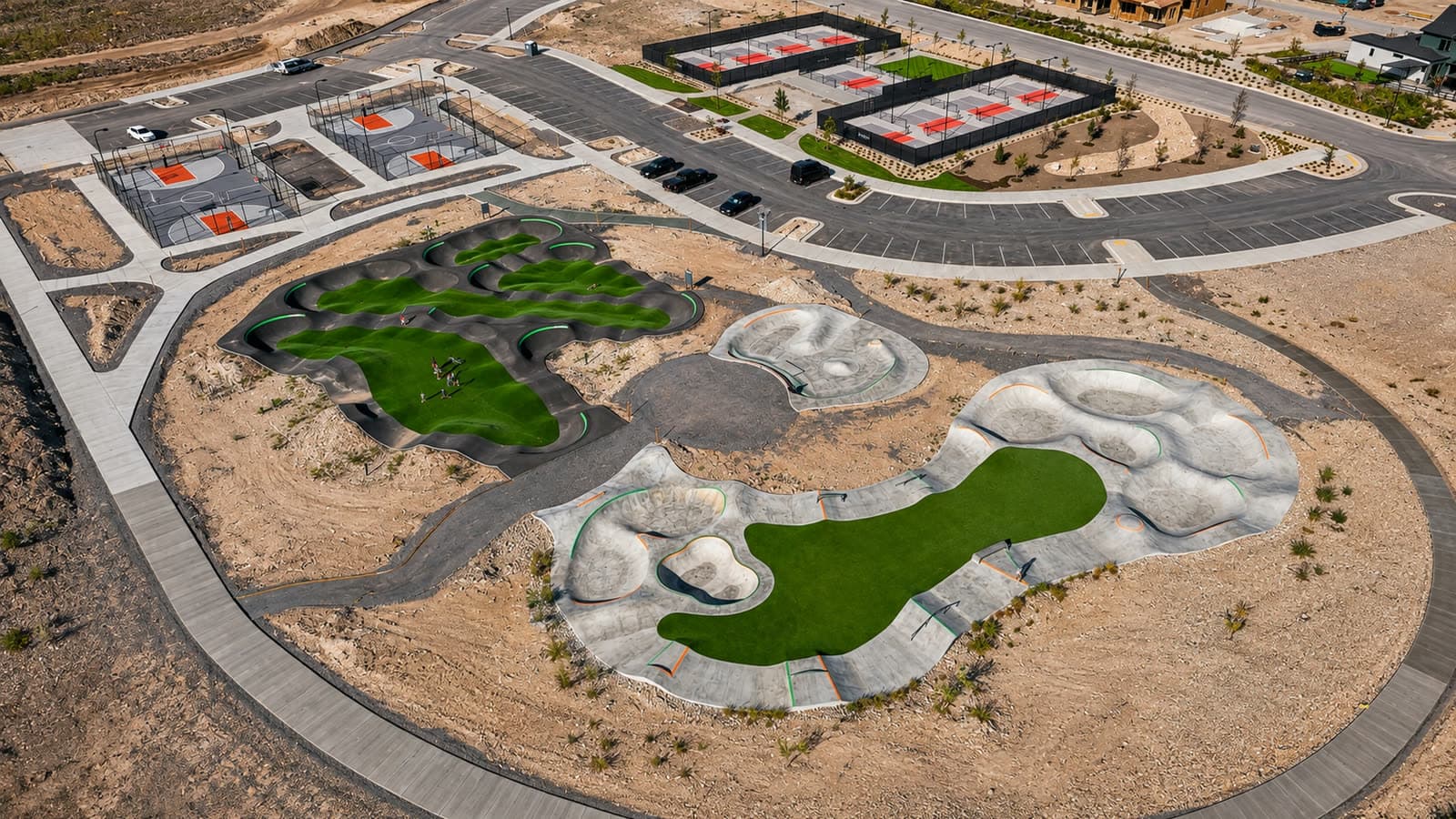 Aerial view of Firefly Park in Eagle Mountain — the bike pump track, skate and wheels park, pickleball courts and basketball courts