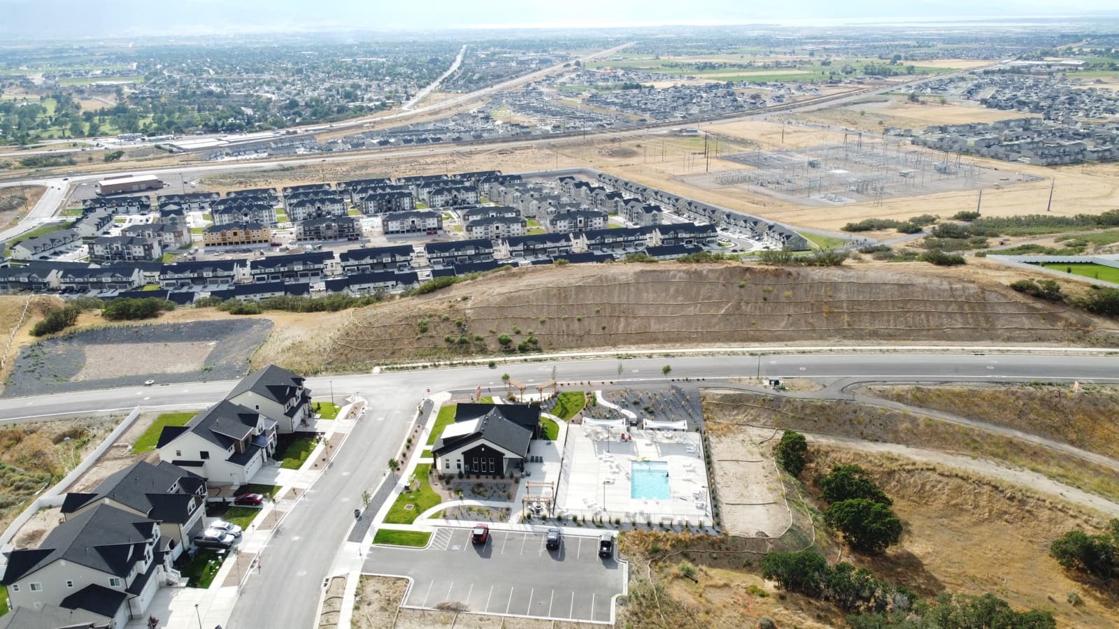 Aerial view of a Harmony Ridge clubhouse and pool surrounded by homes