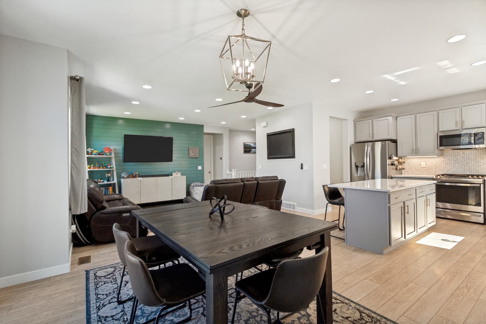 Open main floor from the dining area: living room, dining table, and kitchen island
