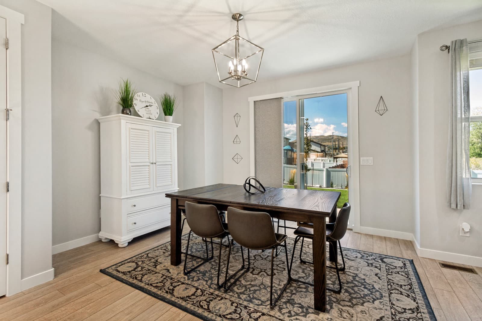 Dining area with a lantern pendant and a sliding door to the backyard