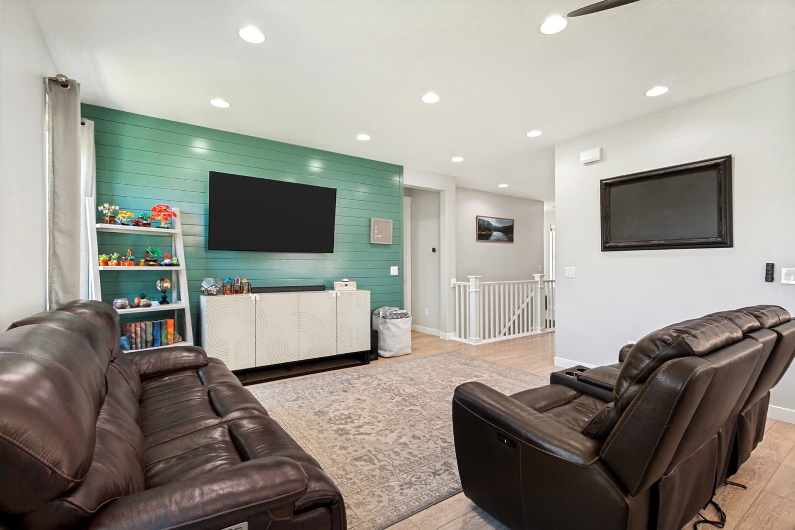 Living room with a teal shiplap accent wall and a ceiling fan
