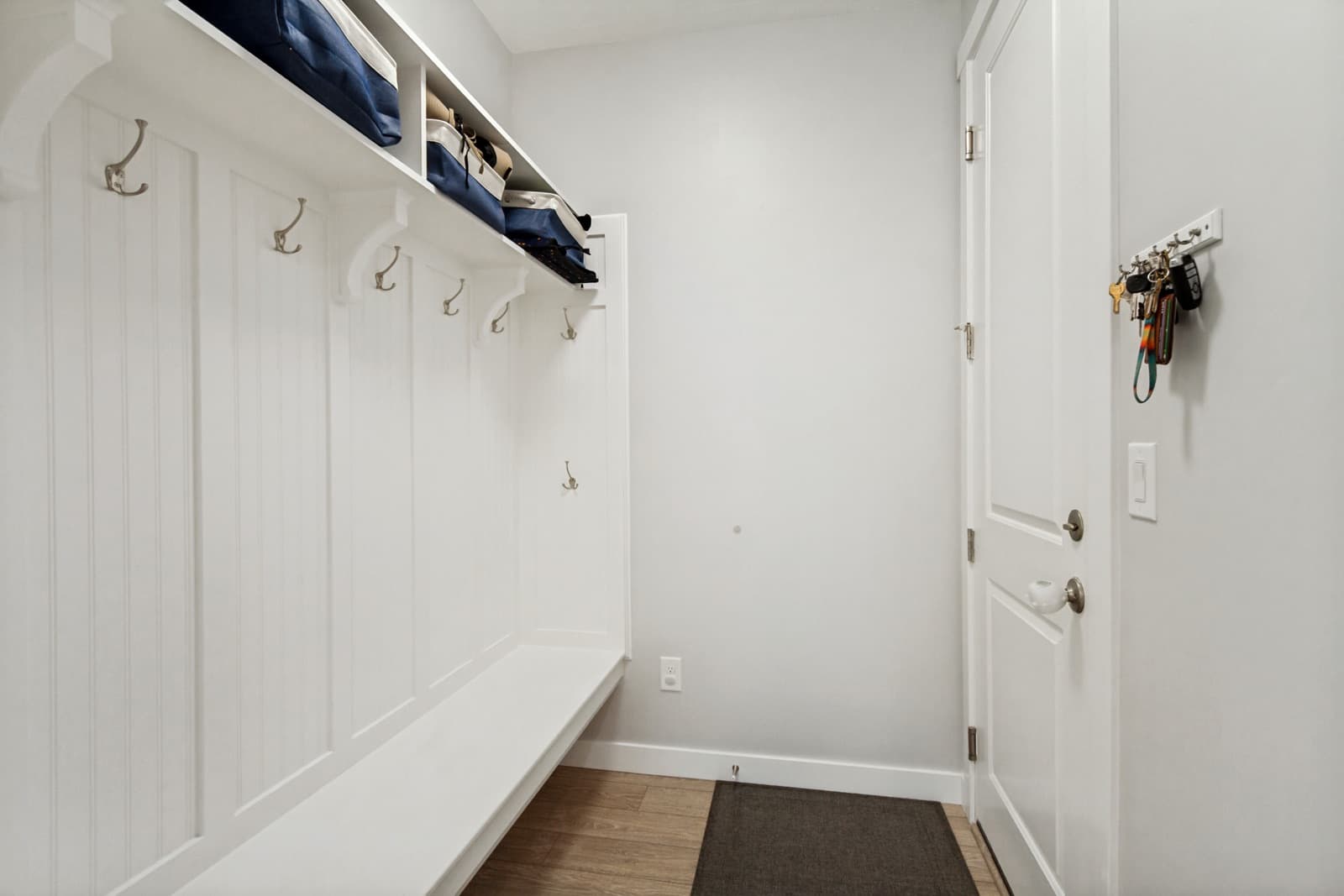 Mudroom with a built-in hall tree, bench, and hooks