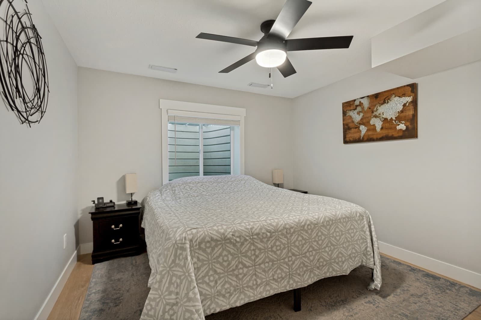 Basement bedroom with an egress window and a ceiling fan
