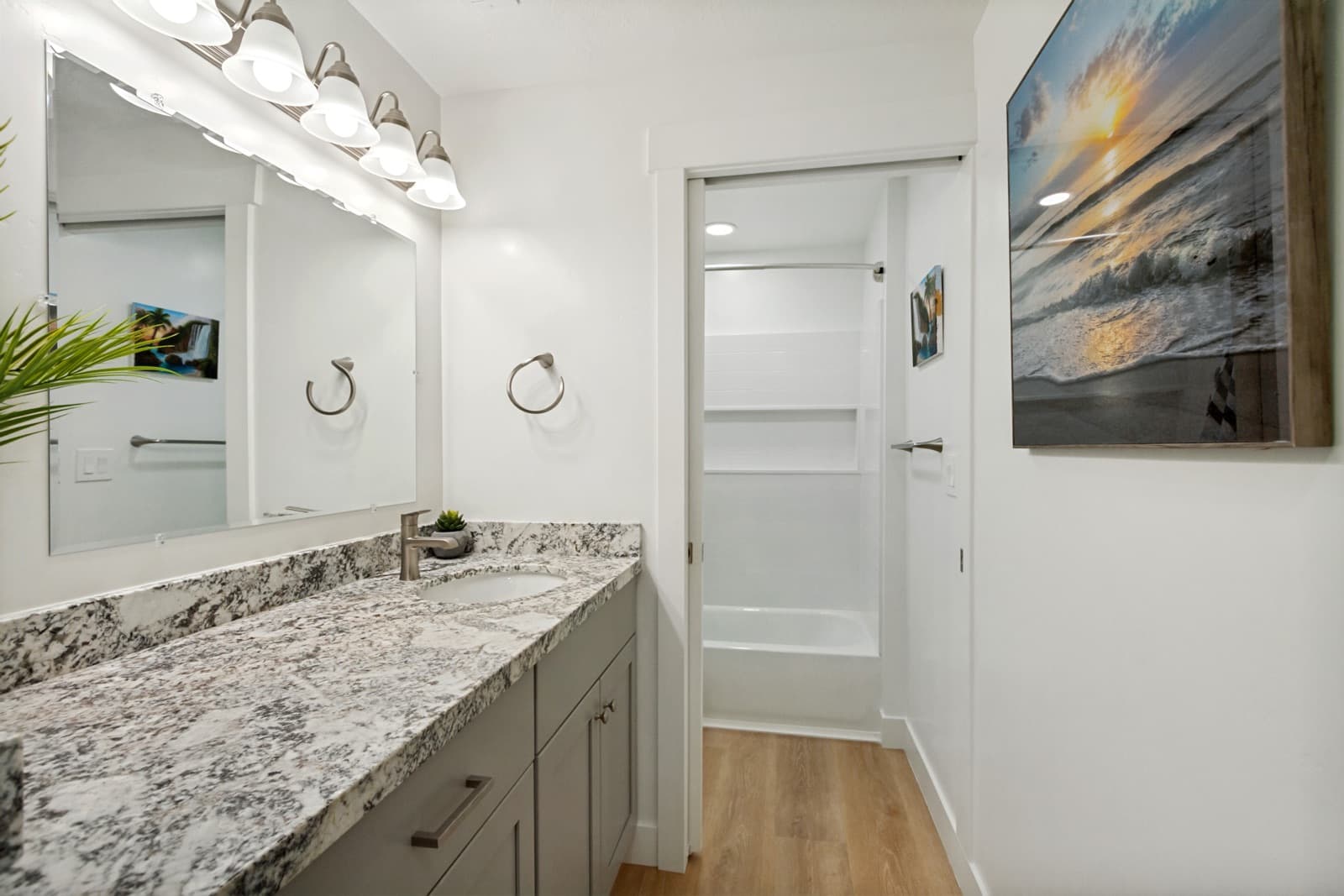 Basement bath with a granite vanity and a tub-shower