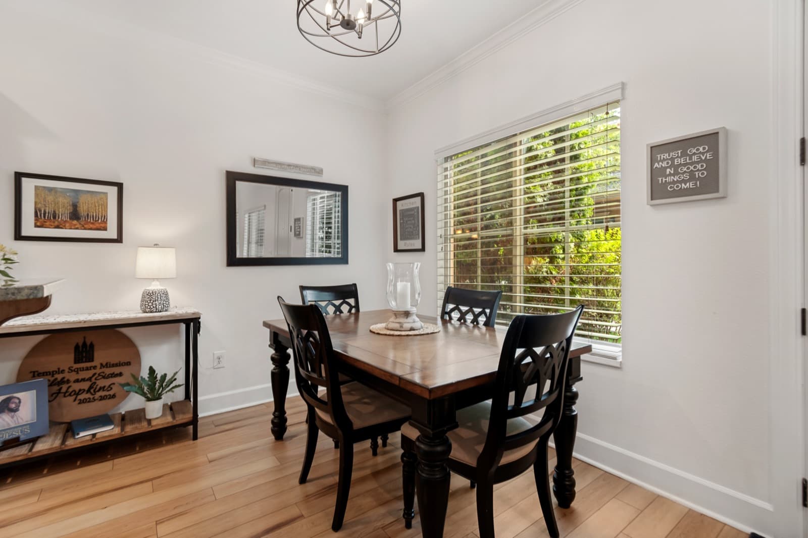 Dining area with a chandelier, crown molding, and a full-height window