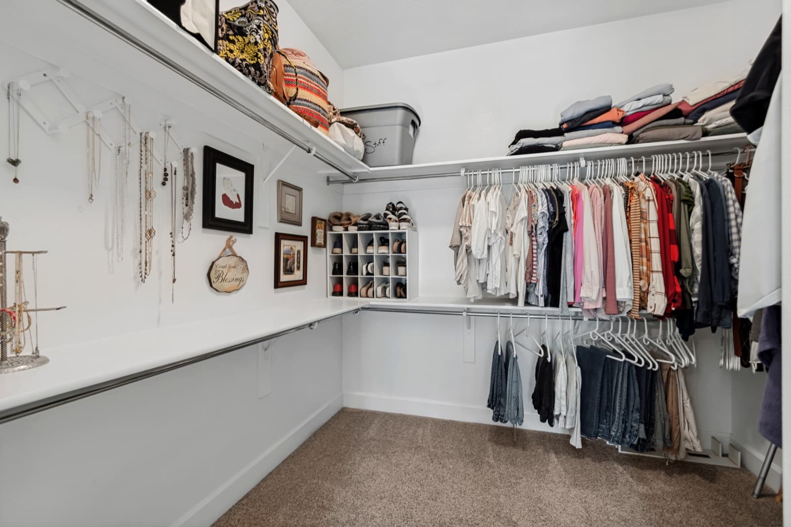 Walk-in closet with a full built-in shelving system and double-tier hanging