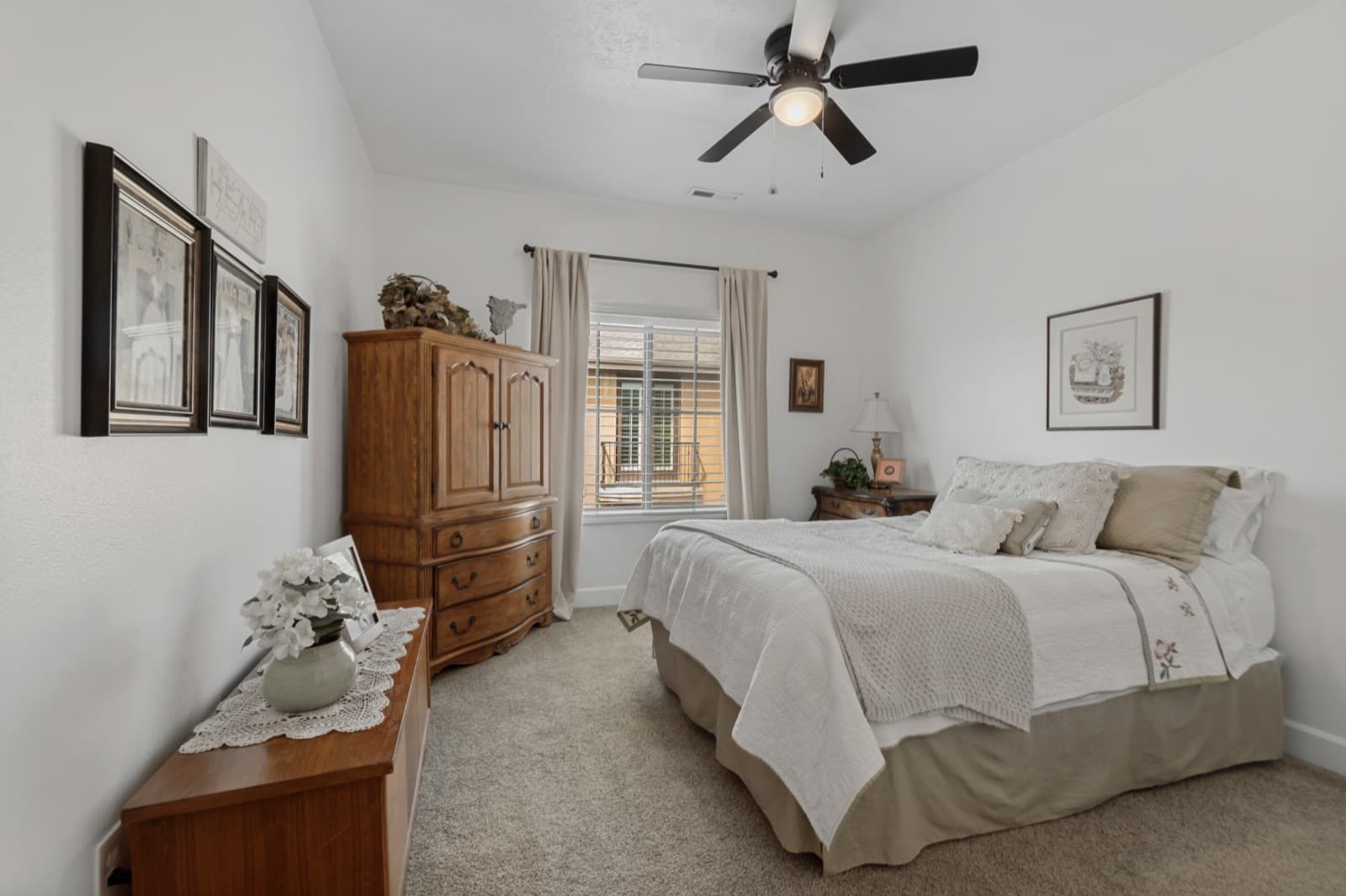 Second bedroom with carpet and a window with plantation shutters