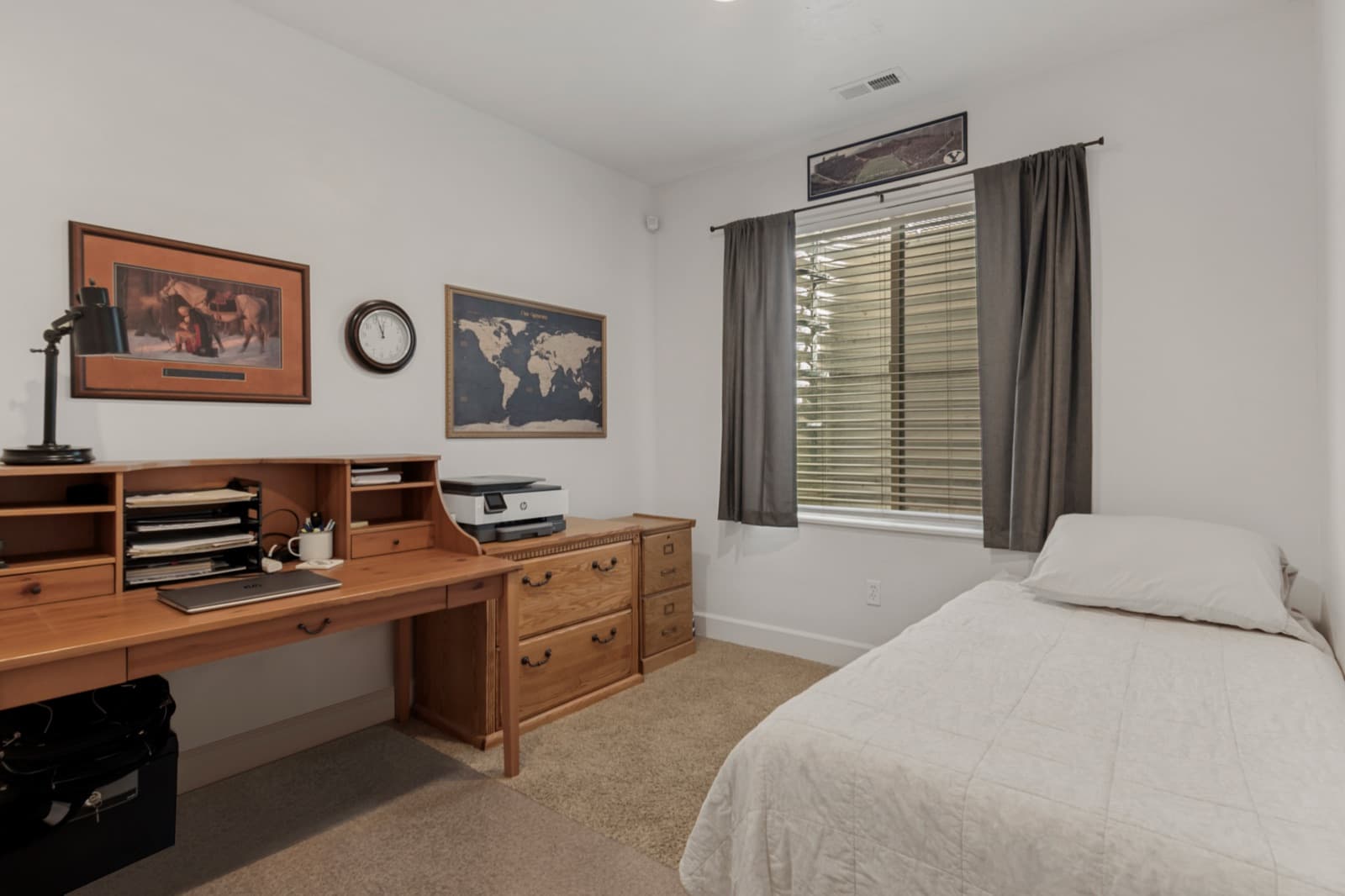 Lower-level fourth bedroom set up as an office and guest room