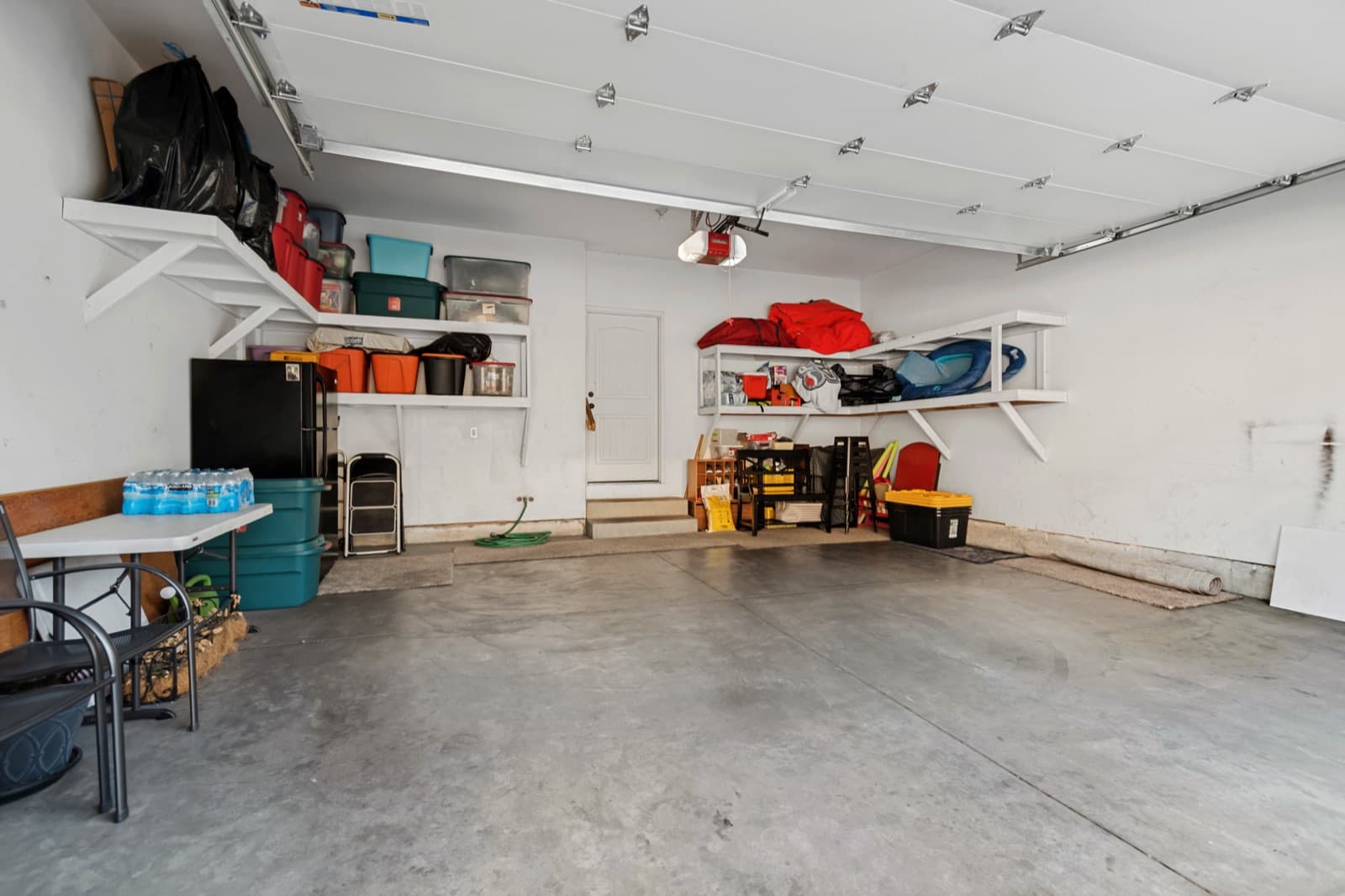 Attached two-car garage with built-in wall shelving