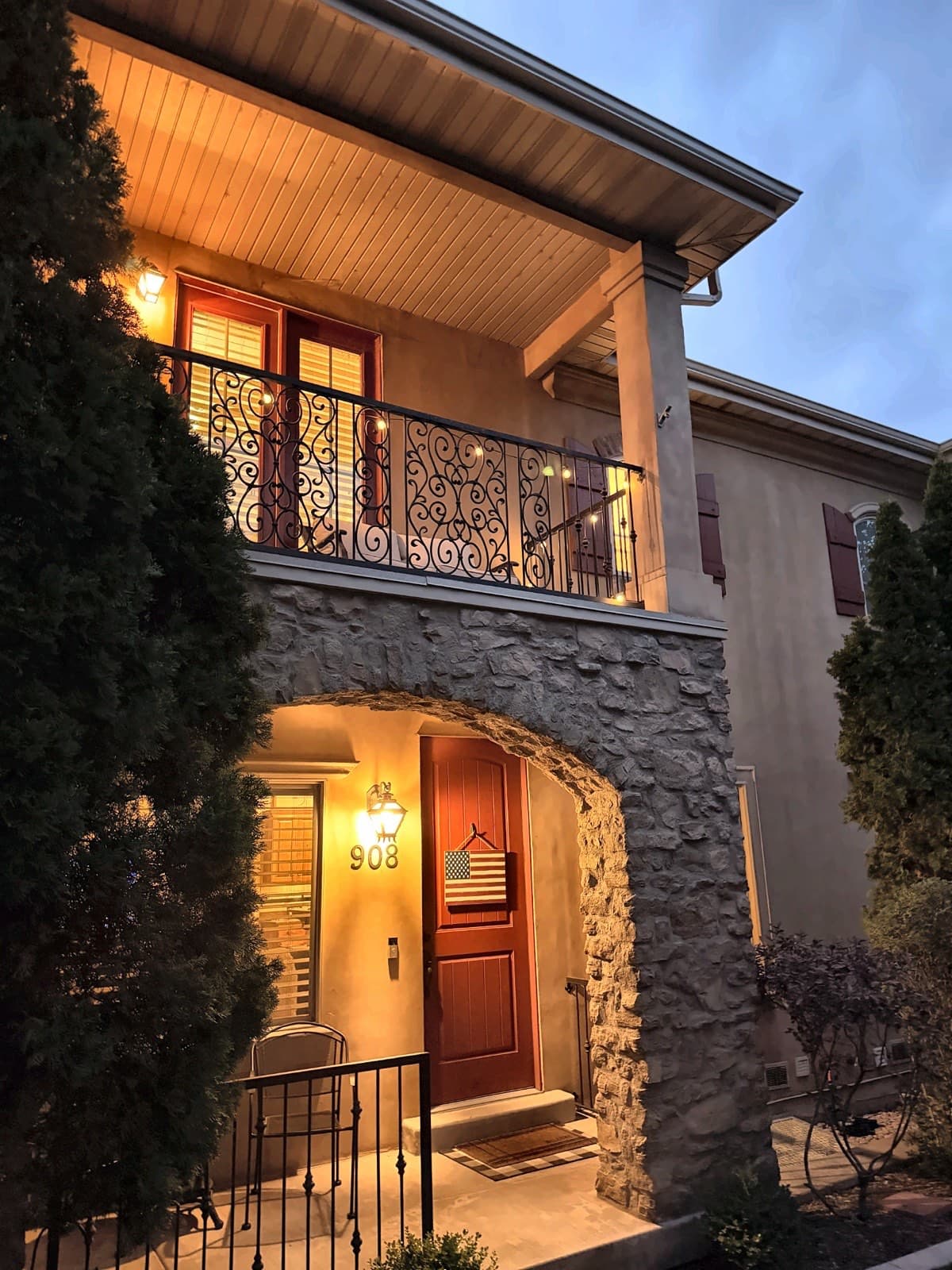 Arched stone entry and covered front porch at 908 N 940 W