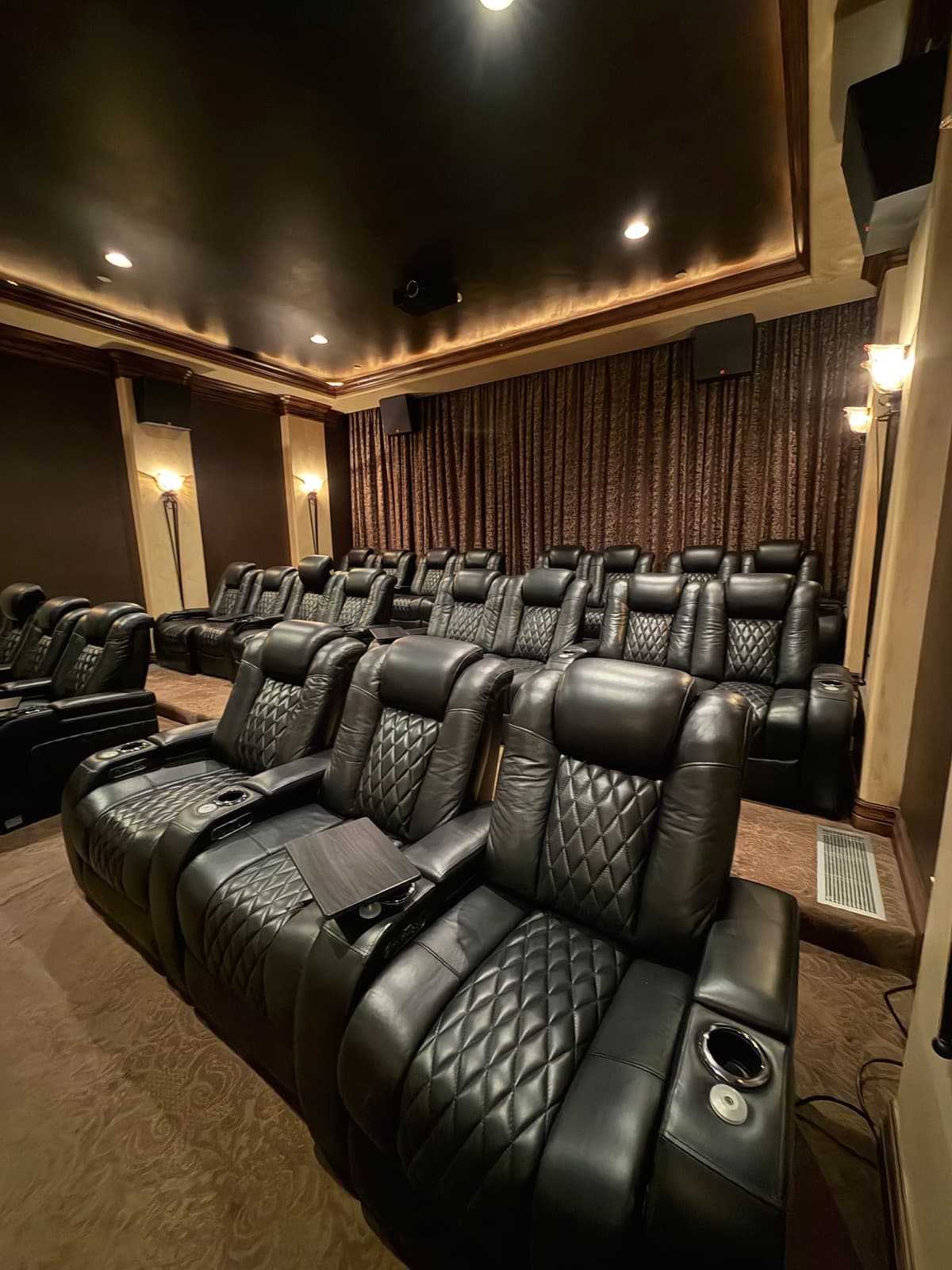 Residents' theater room with rows of recliners