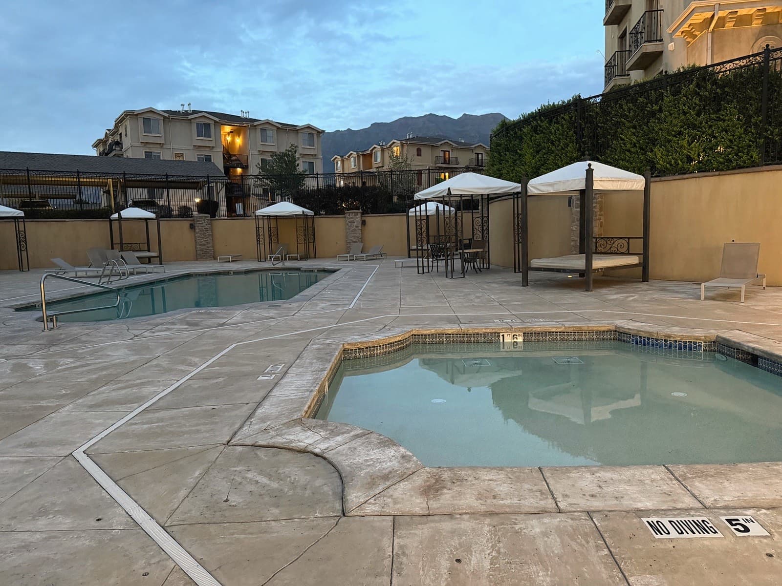 Community pool deck with mountain views