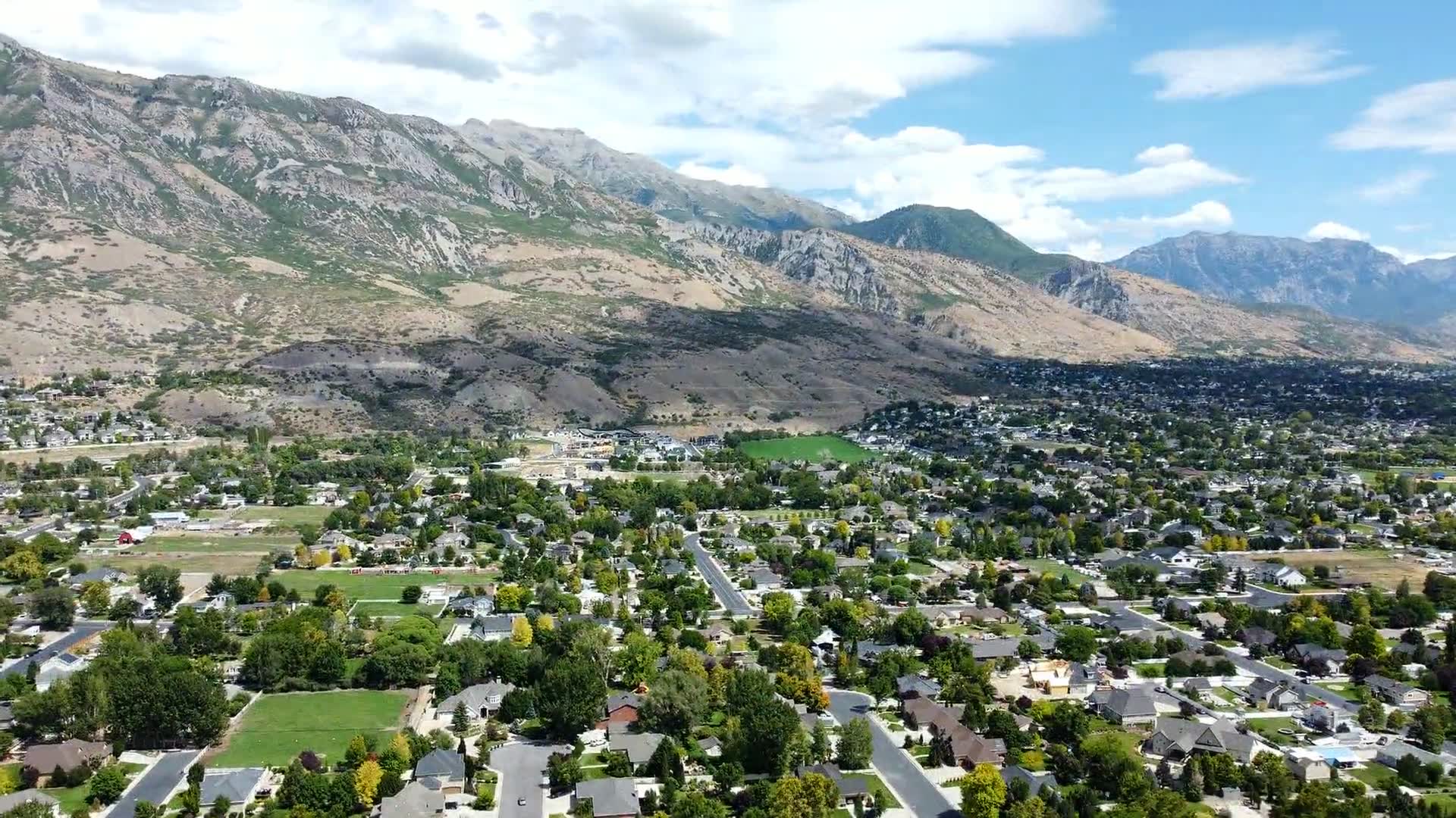 Aerial view of neighborhoods along the Wasatch bench in Utah Valley on a summer afternoon