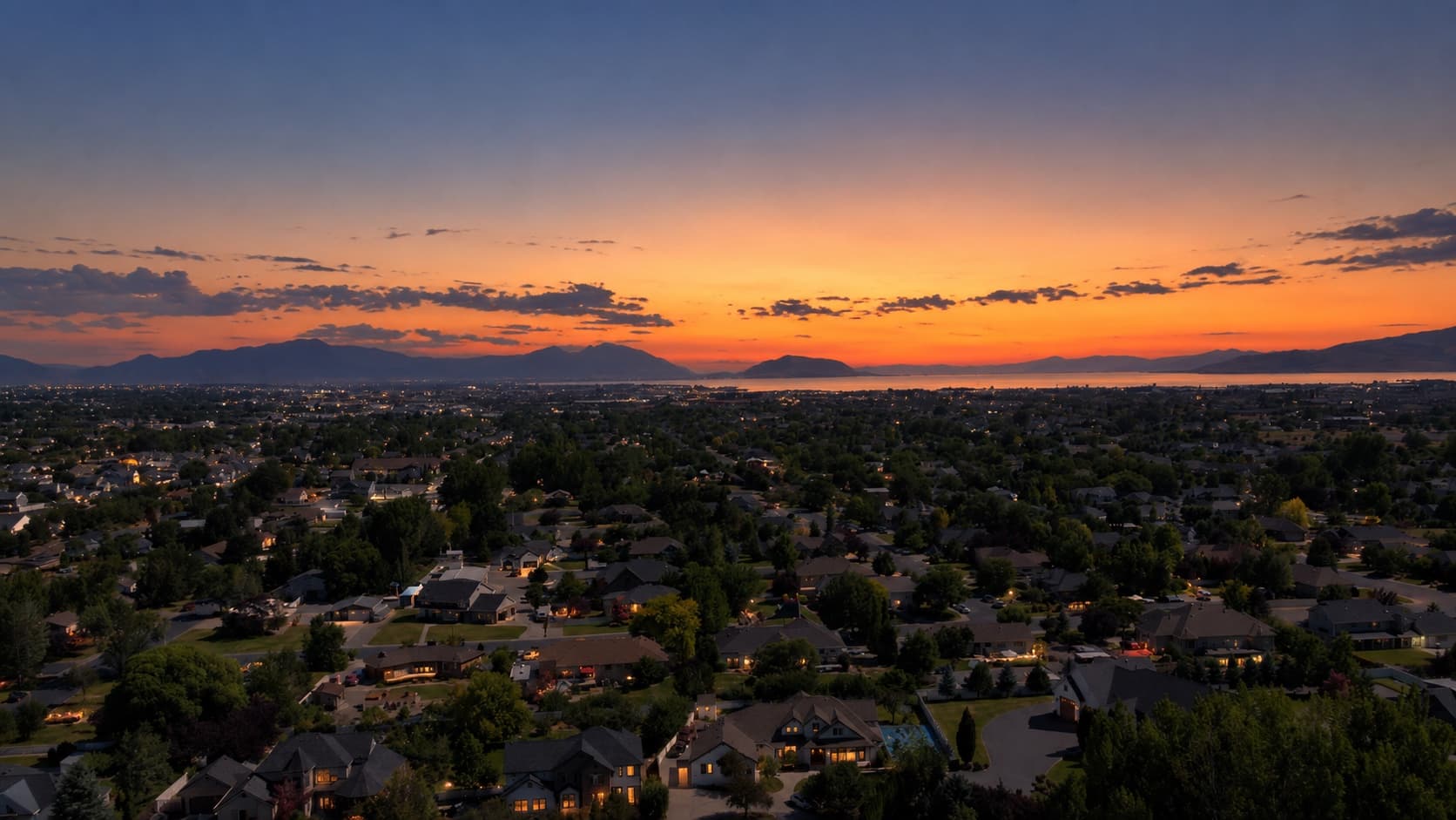 Utah Valley at sunset, looking west over Pleasant Grove neighborhoods toward Utah Lake